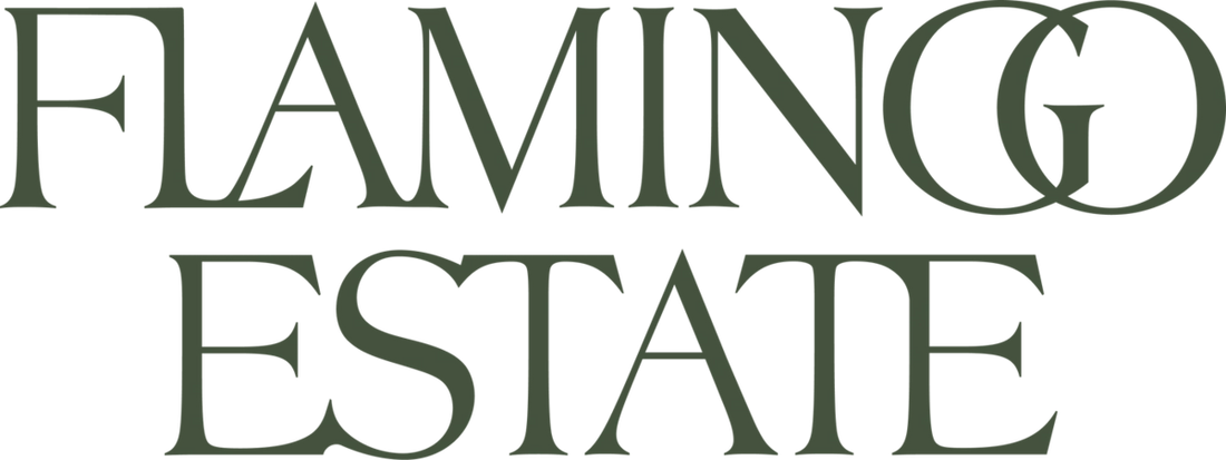 The text 'FLAMINGO ESTATE' is displayed in a dark olive green serif typeface on a solid white background.